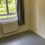 A room with a window in a Winchester house share with lots of natural light